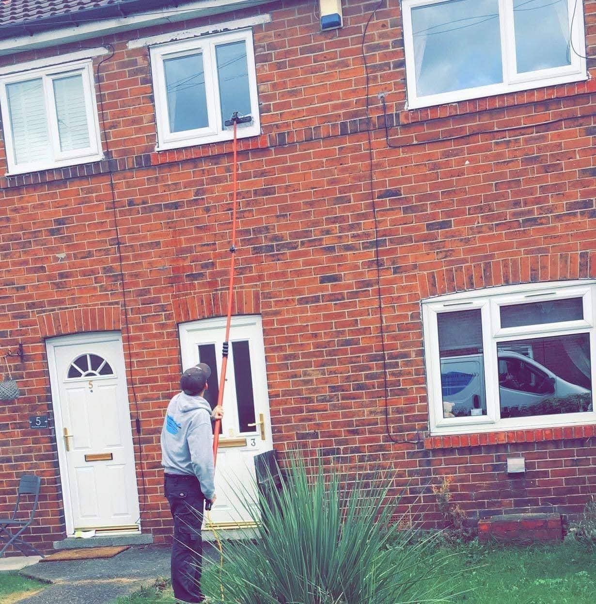 Pontefract Window Cleaners using water-fed pole system on second floor window