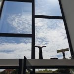Interior window cleaning on tall two-storey window in Pontefract with traditional tools.