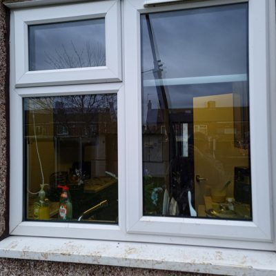 Dirty window with mucky window sills from dogs jumping up in Pontefract